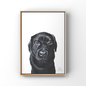 Framed painting of a black labrador dog. The dog has brown eyes and a silky coat.