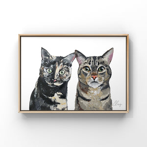 Framed painting of two cats. Both cats have short multi-coloured hair with bright green eyes.